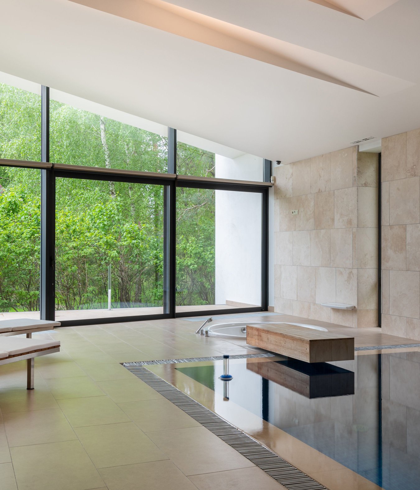 Indoor wellness pool with floor-to-ceiling glazing